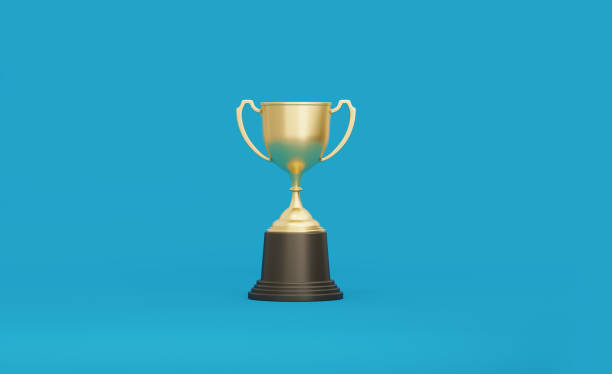 istock Gold Cup Standing over Teal Background 1194397194