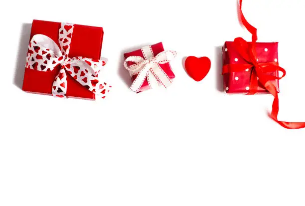 Holiday gifts. Red gift boxes on pink background. Valentines day concept. Christmas gift. Top view, copy space