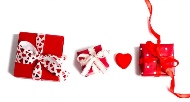 Holiday gifts. Red gift boxes on pink background. Valentines day concept. Christmas gift. Top view, copy space