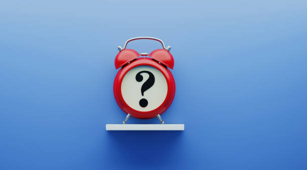 istock Red Alarm Clock with Question Mark over Blue Background 1194399215