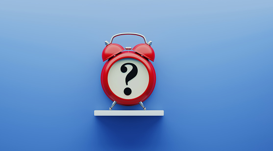 Red alarm clock with question mark over blue background. Reminder concept. Horizontal composition with copy space.