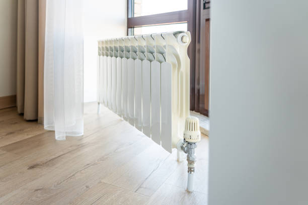 istock White big radiator near window in modern room 1194401093