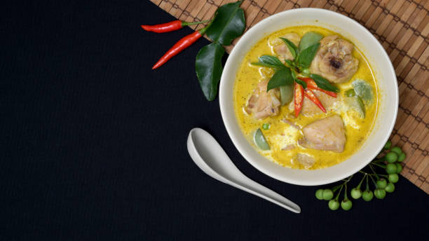 istock Chicken green curry and ingredients on black desk background with copy space 1194401987