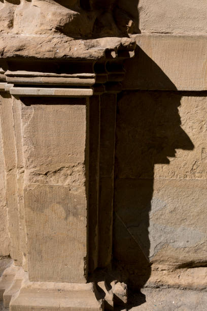 A shadow from a column similar to a persons profile