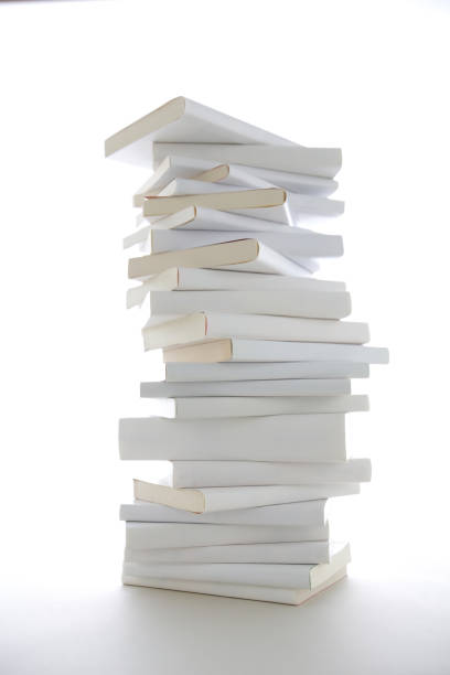 istock Stacked white books and laptop 1194414344