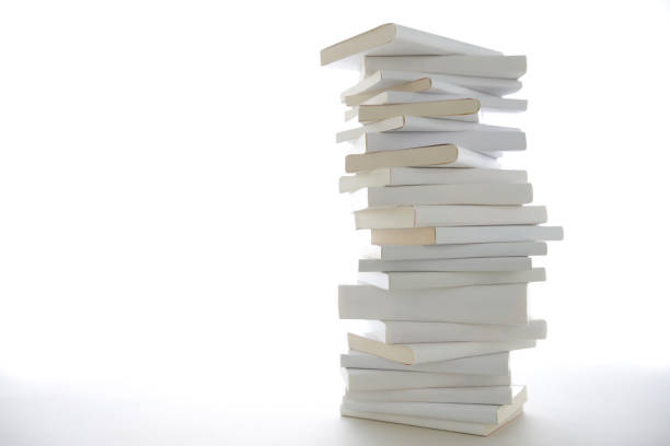 istock Stacked white books and laptop 1194414359