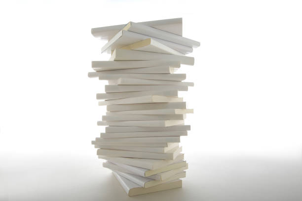 istock Stacked white books and laptop 1194414447