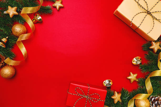 istock Christmas present and pine tree with xmas decoration on Red background 1194414508