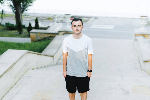 istock Young man is looking thoughtful at the camera in park. 1194415272