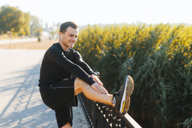 istock Young man stretching outside in the park after some running circles. 1194415674