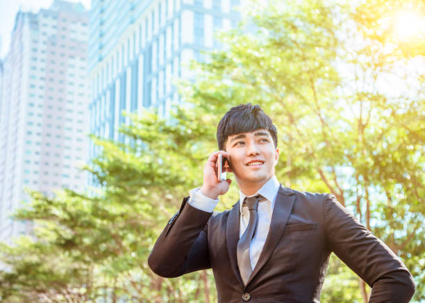 istock asian young businessman talking on mobile phone 1194415721