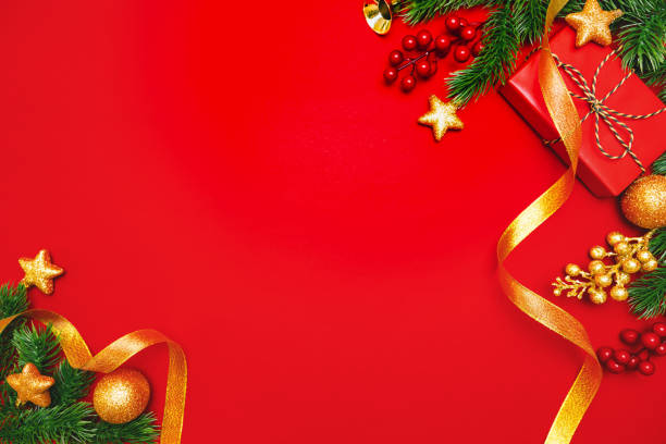 istock Christmas present and pine tree with xmas decoration on Red background 1194416452