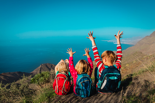 happy kids-boy and girls- travel in mountains near sea, family in Canary islands, Spainvacation concept