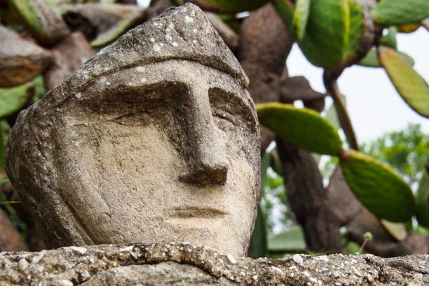 Faces engraved on the rock. Enchanted Castle of Sciacca, open-air museum in Agrigento, Sicily in Italy