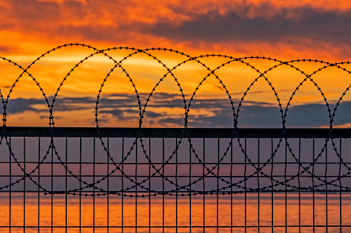 sunset and fences at the sea side.
