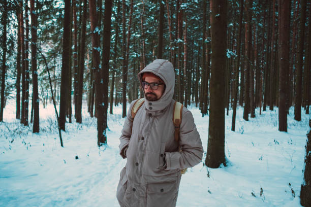 istock young man in a winter snowy forest 1194422098