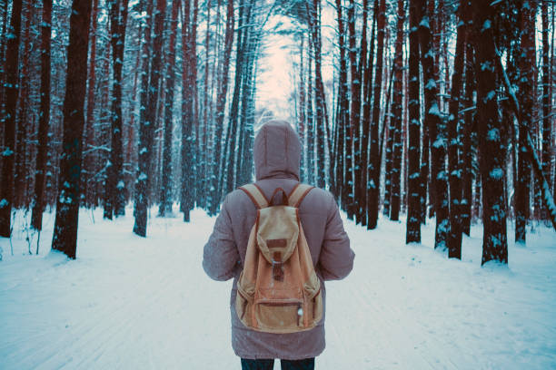 istock young man in a winter snowy forest 1194422192