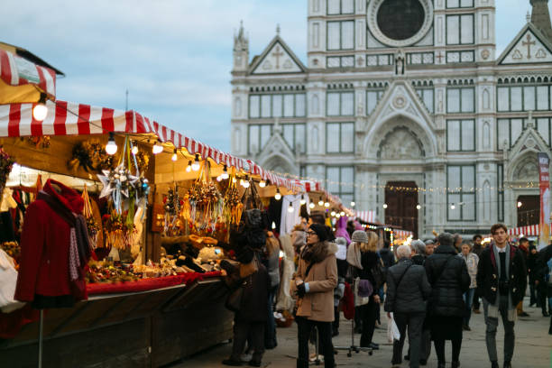Christmas market in historical square of Florence People enjoying German Christmas market held in Piazza di Santa Croce of Florence, Italy piazza di santa croce stock pictures, royalty-free photos & images