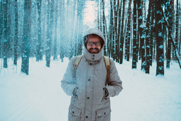 istock young man in a winter snowy forest 1194422555