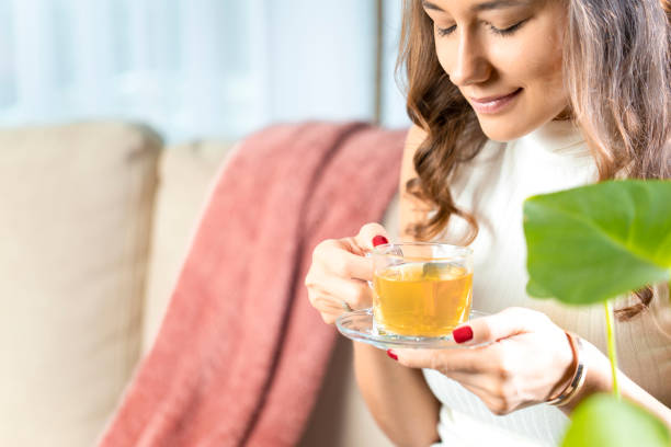 woman drinking herb tea - herbal tea imagens e fotografias de stock