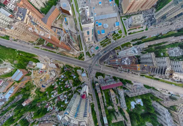 Photo of Abstract aerial view of square in the city with traffic, streets and a lot of tall colored buildings with green trees with drop effect perspective. The point of an air strike in a game or in war.