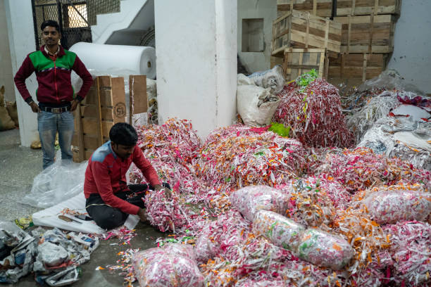 Workers at a brass store use shredded paper to prepare fragile statues and items for shipping all over the world Delhi, India - December 14, 2019: Workers at a brass store use shredded paper to prepare fragile statues and items for shipping all over the world old delhi stock pictures, royalty-free photos & images