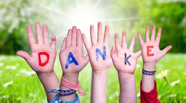 Children Hands Building Word Danke Means Thank You, Grass Meadow stock photo