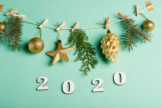 istock New Year's content 2020 numbers on red strings are half-hung, on a mint background. 1194428468
