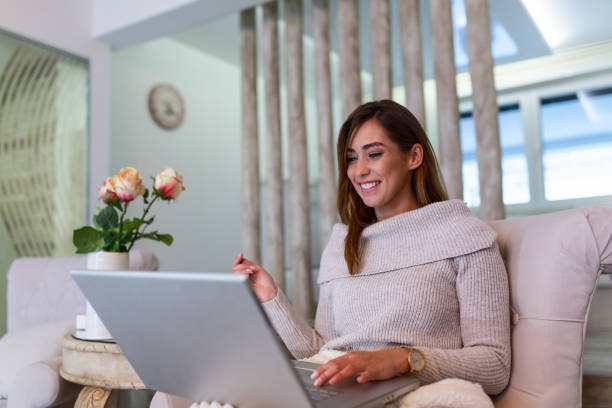 istock Nice beautiful lady with long hair work at the notebook sit down on the sofa at home - check on oline shops for cyber monday sales - technology woman concept for alternative office freelance 1194428610