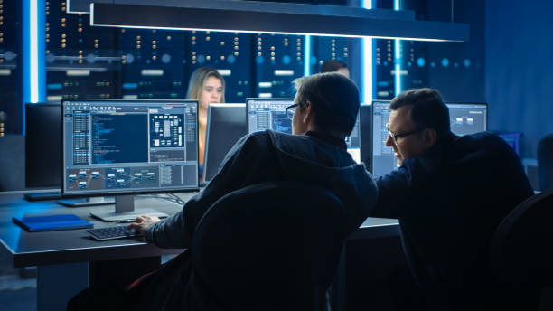 Team of IT Programers Working on Desktop Computers in Data Center Control Room. Team of Young Professionals Working In Software and Hardware Development, Doing Coding stock photo