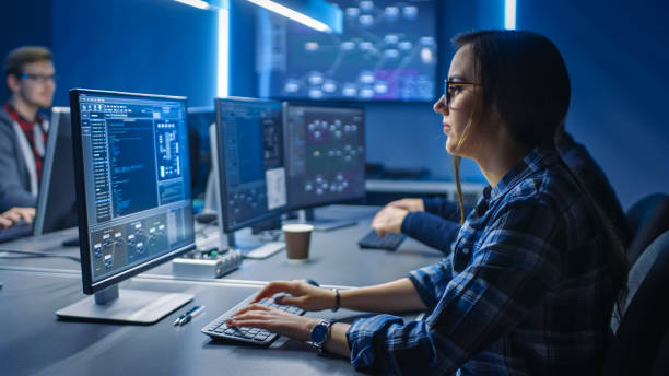 smart young female it programer working on desktop green mock-up screen computer in data center system control room. équipe de jeunes professionnels programsophisticated code - computer network order design engineer photos et images de collection