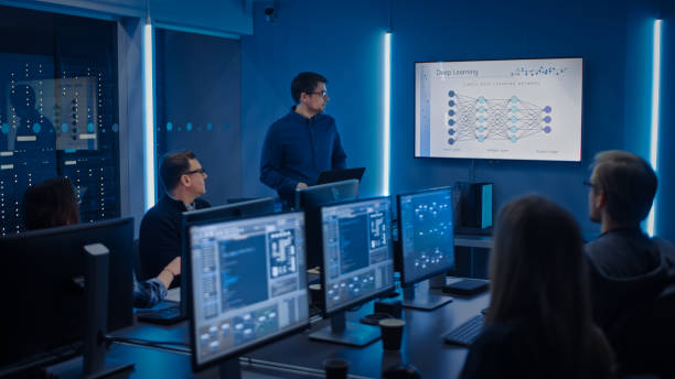 istock Team of Professional IT Developers Have a Meeting, Speaker Talks about New Blockchain Based Software Development Shown on TV. Concept: Deep Learning, Artificial Intelligence, Data Mining, Neural Network 1194430849