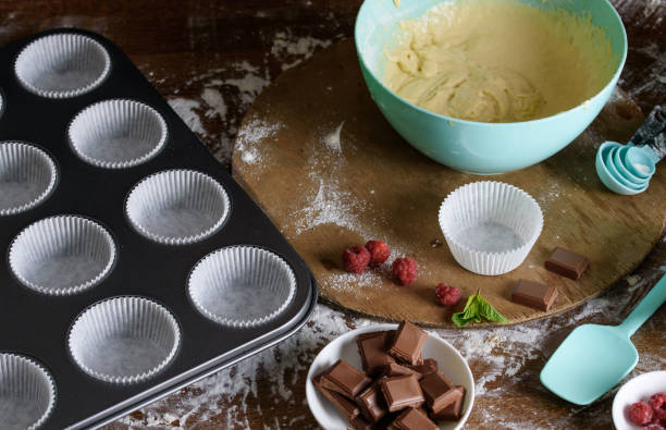istock The process of baking delicious muffins with berries, white cream, chocolate. 1194431849