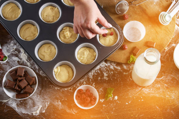 istock The process of baking delicious muffins with berries, white cream, chocolate. 1194431888