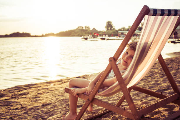 istock Small kid enjoying in sunset at the beach. 1194431973