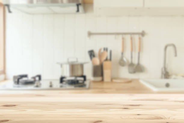 istock Kitchen background blur with wooden top table clean white for kitchenware montage advertising banner layout. 1194434240