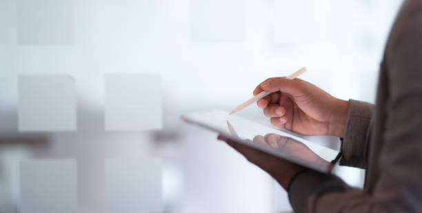 istock Close-up view of young businessman using digital tablet 1194436696