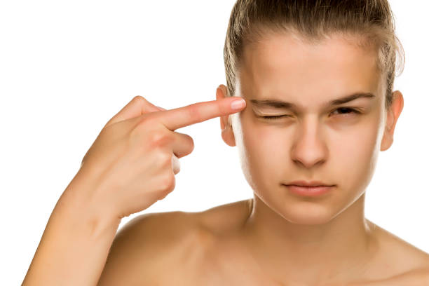 istock young beautiful woman touches her forehead on white background 1194438897