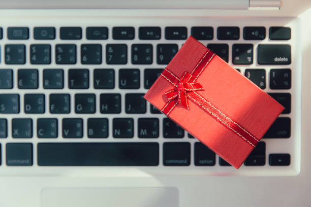 istock Gift box of small precious present on laptop computer keyboard for newyear or black friday online shopping concept. 1194440544