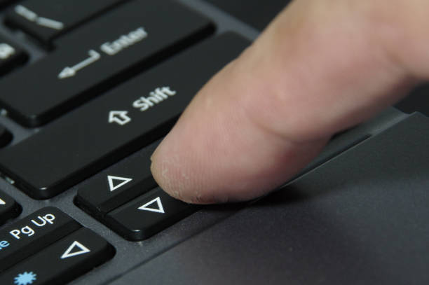 istock A finger hitting computer keyboard Arrow signs on notebook keyboard 1194441208