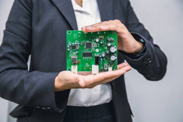istock Business people showing printed circuit board new tech computer unit digital device in hand. 1194441445