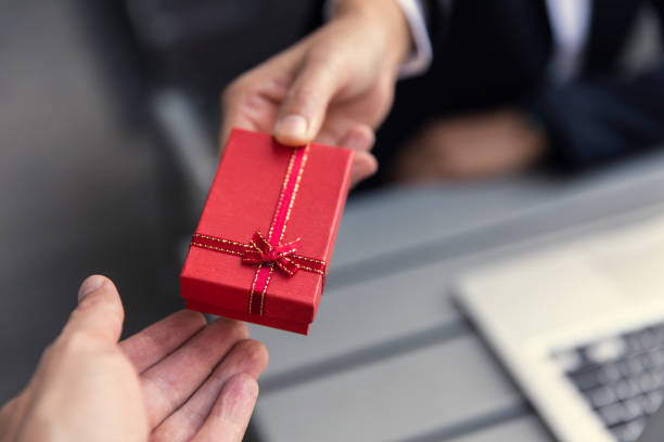 Business boss giving present gift box to office staff partner for job bonus concept. Business boss giving present gift box to office staff partner for job bonus concept. bribing stock pictures, royalty-free photos & images