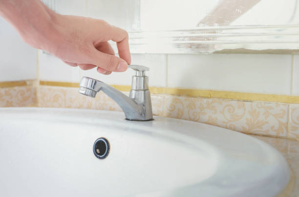 istock hand closing the tap to save water 1194447076