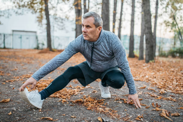 istock Senior man jogs into a public park 1194448636