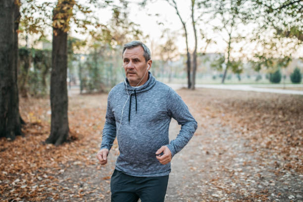 istock Senior man jogs into a public park 1194449470