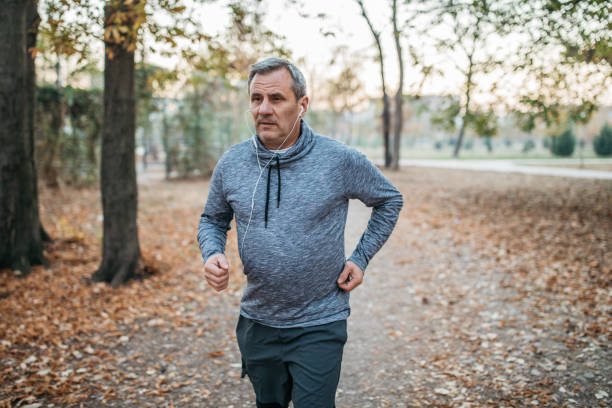 istock Senior man jogs into a public park 1194449471