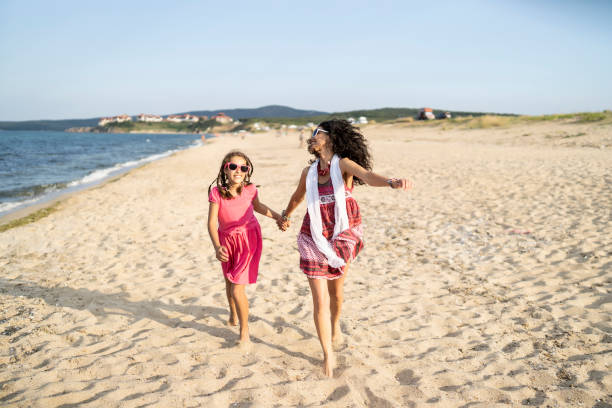 istock Mother and daugther playing on beach 1194450119