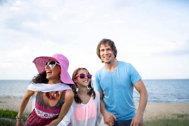 istock Happy family enjoying summer vacations on beach 1194450126