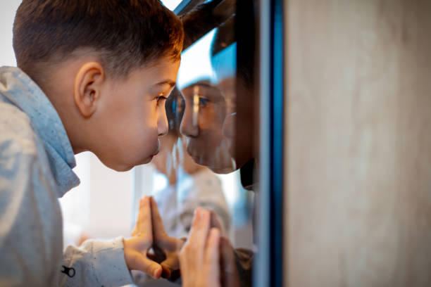 istock Cute boy looking through oven glass 1194452071