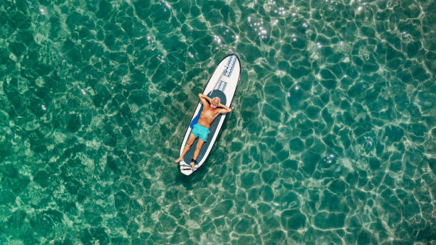 istock Senior man relaxing on a paddleboard 1194452074